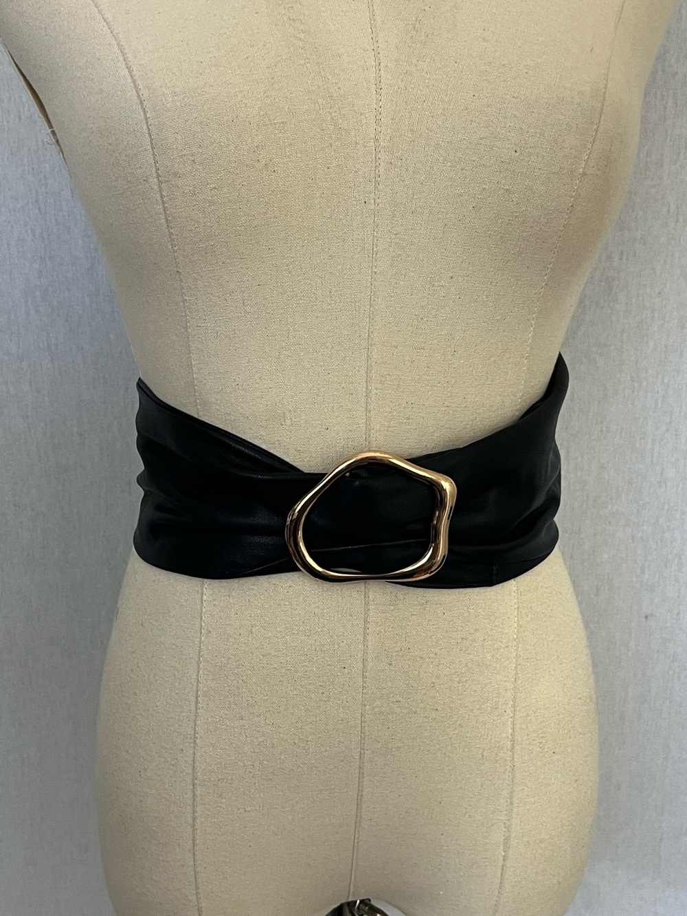 Wide black faux leather belt with gold tone buckle